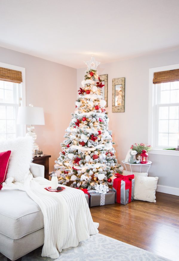 Snowy White Christmas Tree With Lots Of Red dwellingdecor