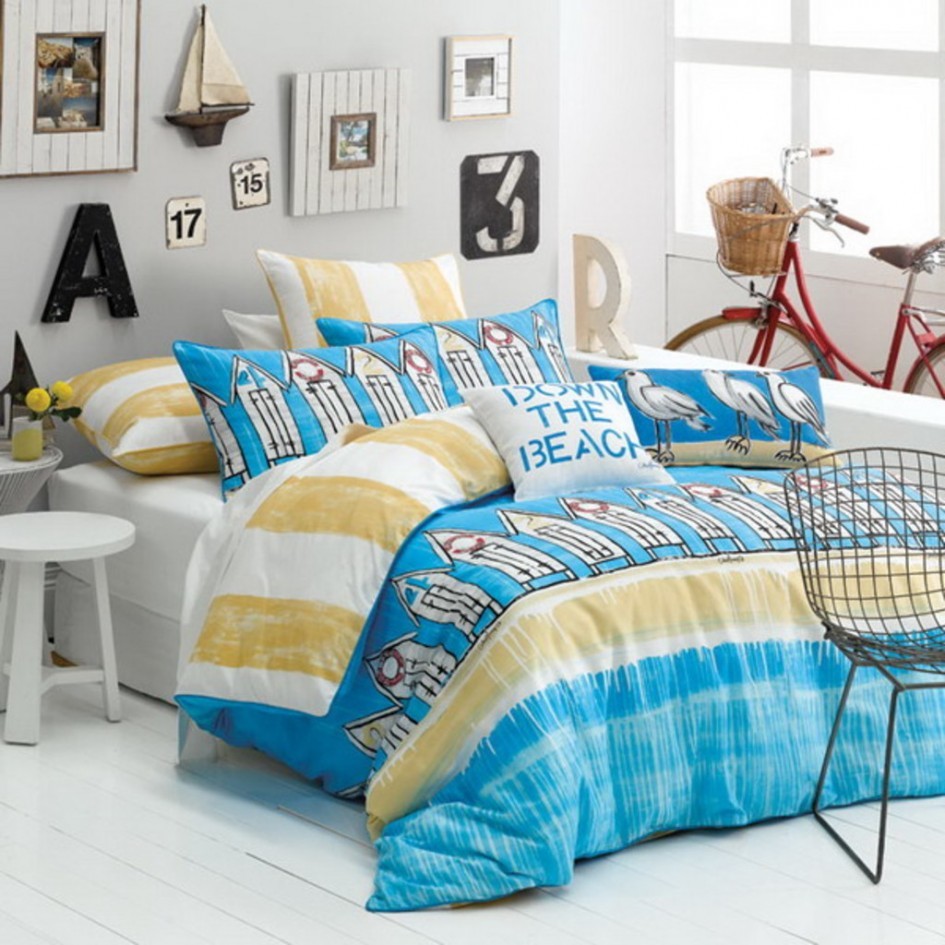 Beach style bedroom with white Beadboard Floor White Stool Blue Pattern Quilt Down