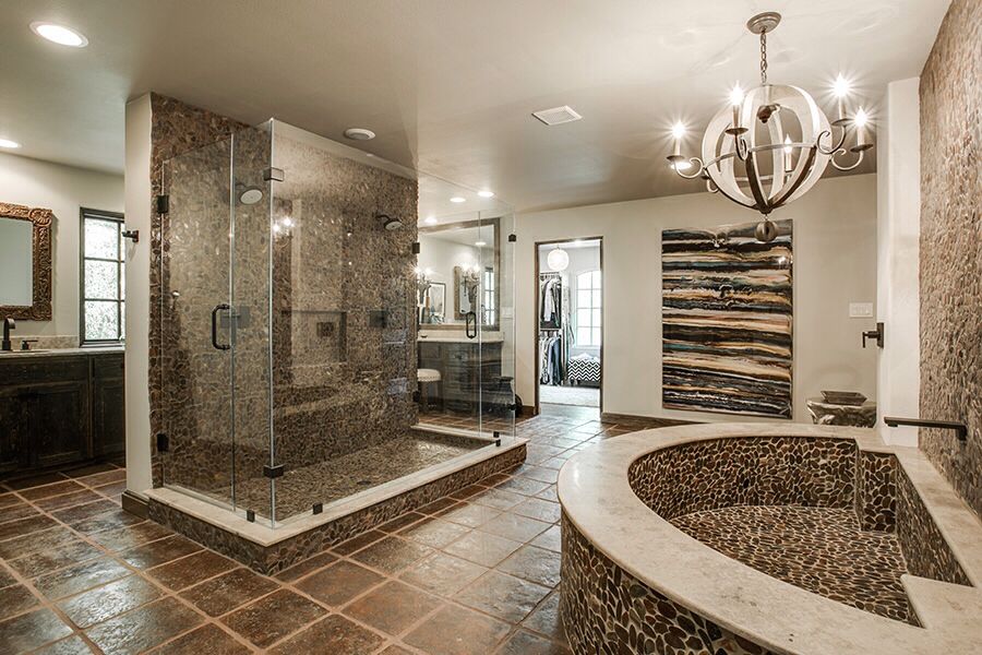 Rustic master bathroom with a chandelier