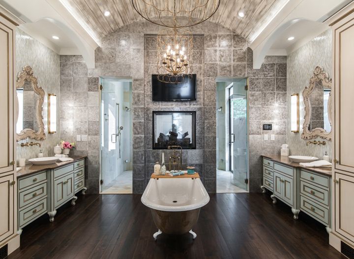 luxurious master bathroom with clawfoot tub and fireplace
