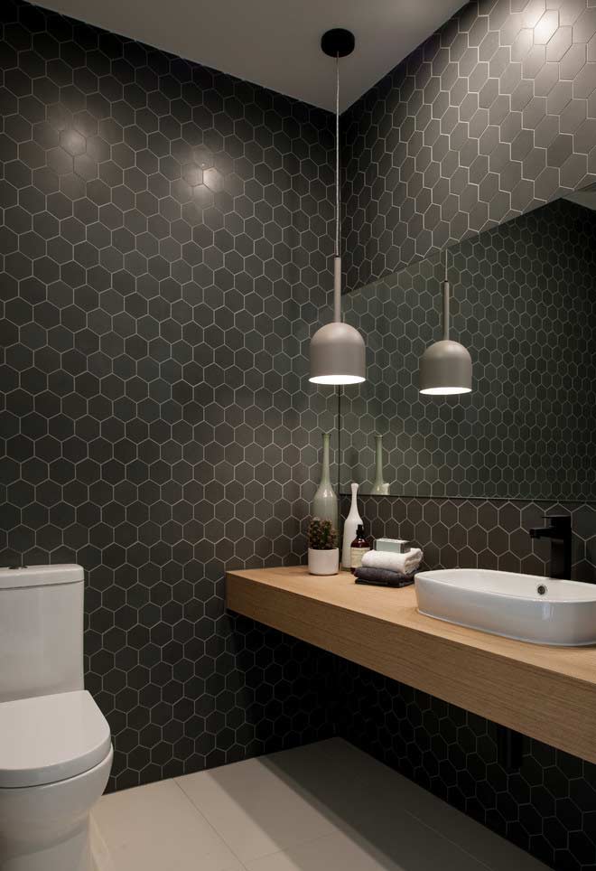 Black hexagonal inserts on the walls with spots of light to increase the illumination