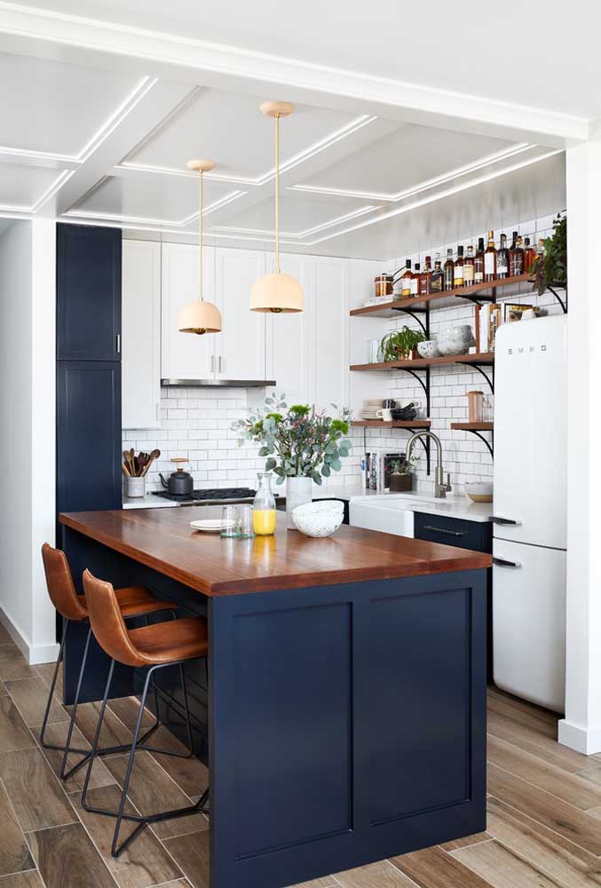 13. This small American kitchen looks amazing with the blue hue and the shape of the wider counter so that it looks like a dining table